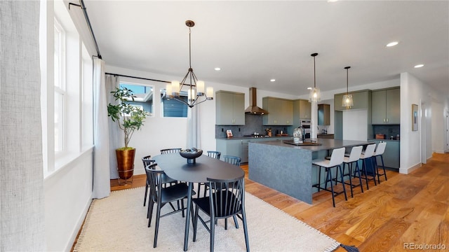 dining room with a chandelier and light wood-type flooring