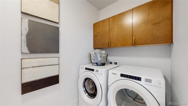 laundry room with cabinets and washing machine and dryer