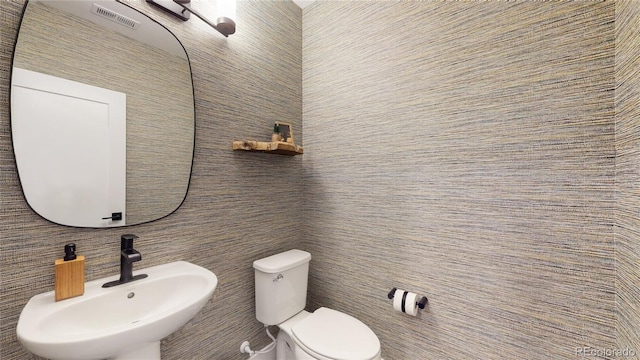 bathroom featuring sink and toilet