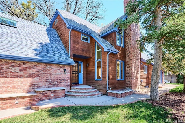 view of front of house with a chimney and a front lawn