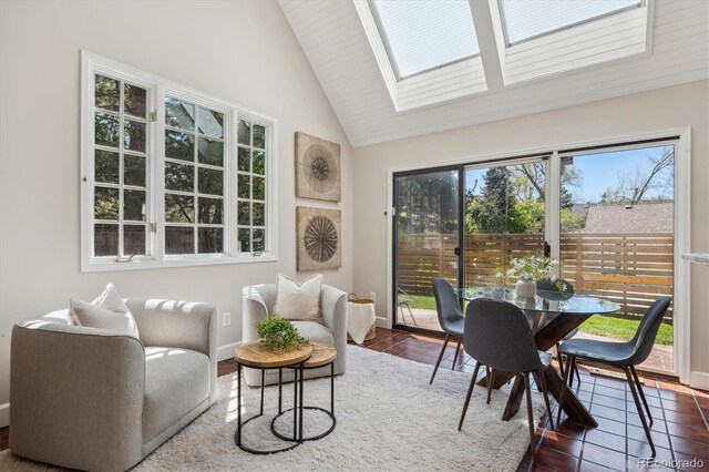 sunroom featuring lofted ceiling and a skylight