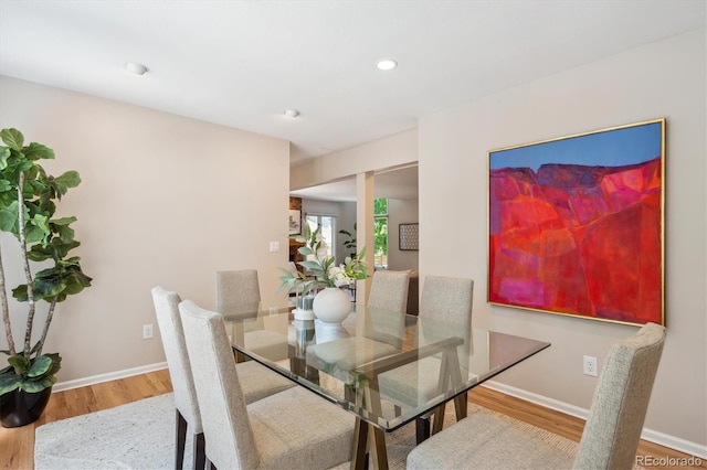 dining room with wood finished floors, baseboards, and recessed lighting