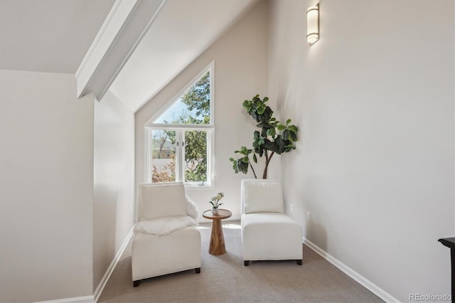 living area featuring carpet and baseboards