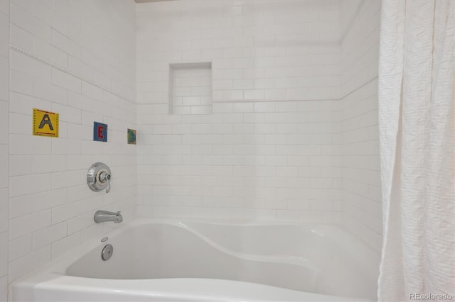 bathroom with shower / bath combo with shower curtain