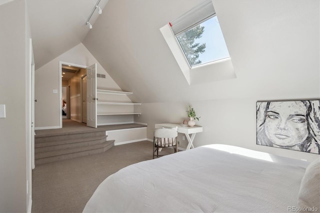 carpeted bedroom featuring lofted ceiling, a skylight, and baseboards
