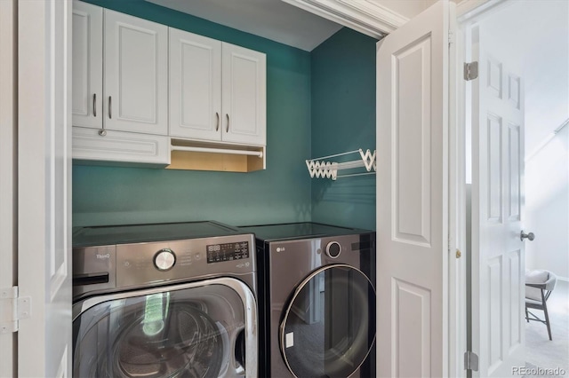 laundry room with separate washer and dryer and cabinet space