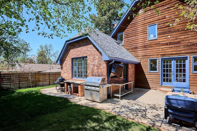 back of property featuring french doors, a patio, and brick siding