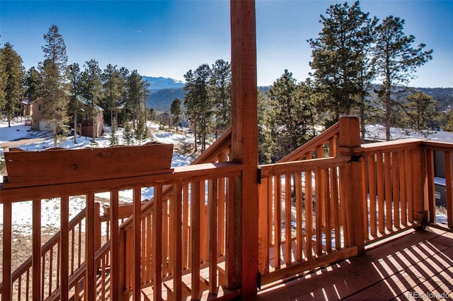 snow covered deck featuring a mountain view