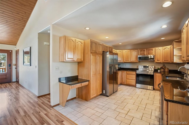 kitchen with stainless steel appliances, lofted ceiling, sink, and light brown cabinets