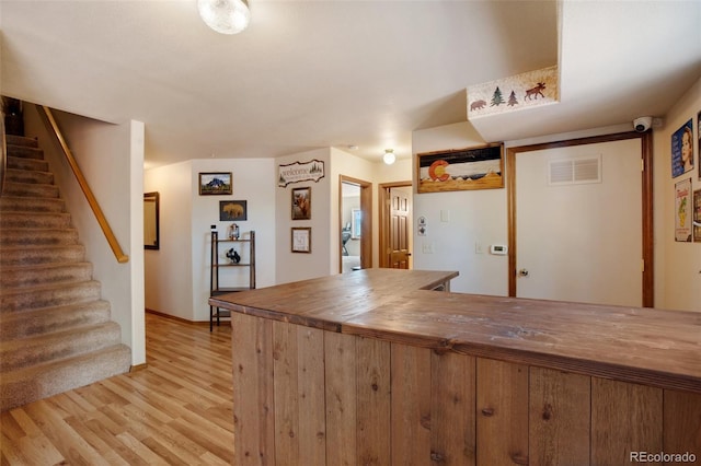 kitchen featuring butcher block counters and light hardwood / wood-style floors