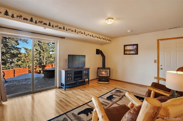 350 Panther Ct, Woodland Park, CO 80863 - living area featuring a wood stove, visible vents, and wood finished floors