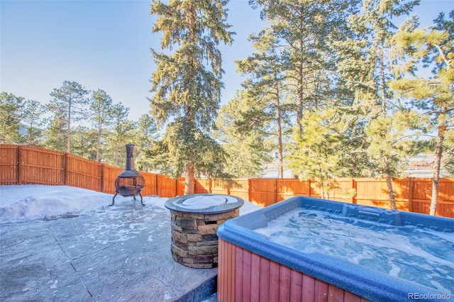 350 Panther Ct, Woodland Park, CO 80863 - view of patio / terrace featuring an outdoor fire pit, a hot tub, and a fenced backyard