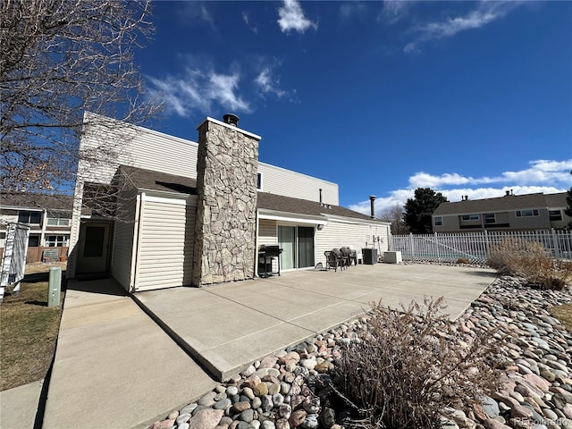 back of house with central AC, a patio, a chimney, and fence