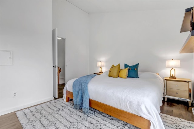 bedroom featuring baseboards and wood finished floors