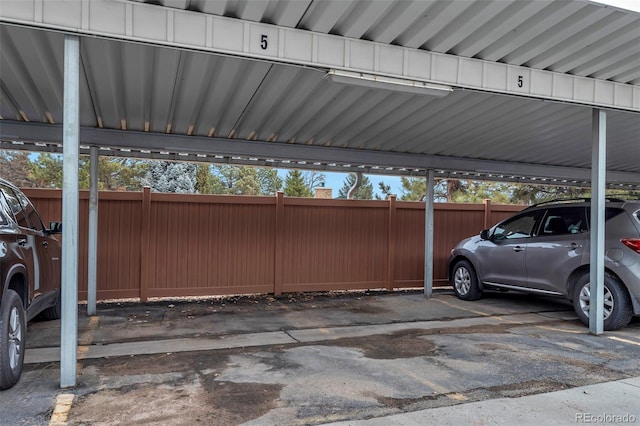 covered parking lot with fence