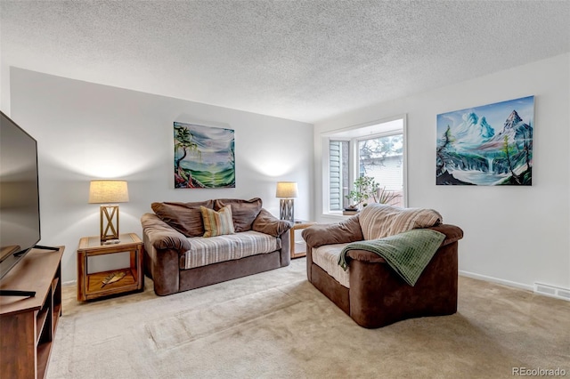 carpeted living room with visible vents, a textured ceiling, and baseboards