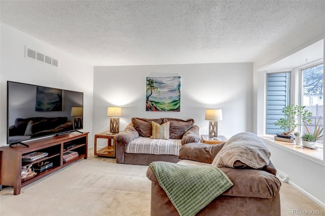 living room with baseboards, visible vents, a textured ceiling, and carpet flooring