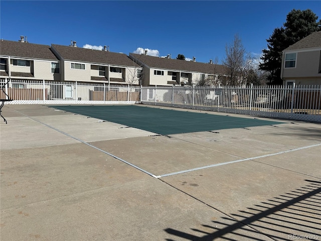 view of swimming pool with a residential view and fence