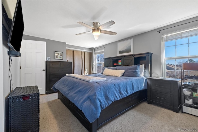 bedroom with light carpet and ceiling fan