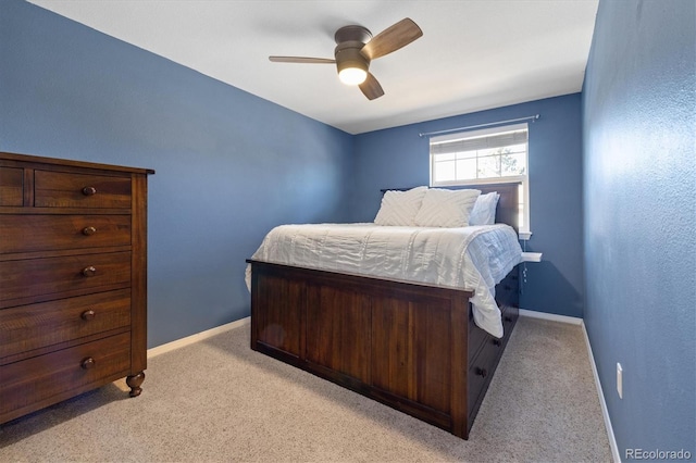 bedroom featuring ceiling fan, baseboards, and light colored carpet