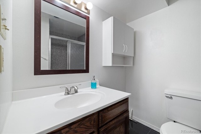 full bathroom with toilet, a stall shower, and vanity