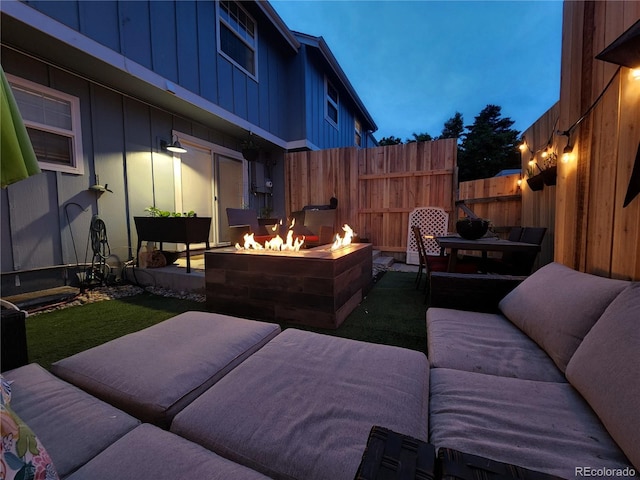 view of patio featuring an outdoor living space with a fire pit and fence