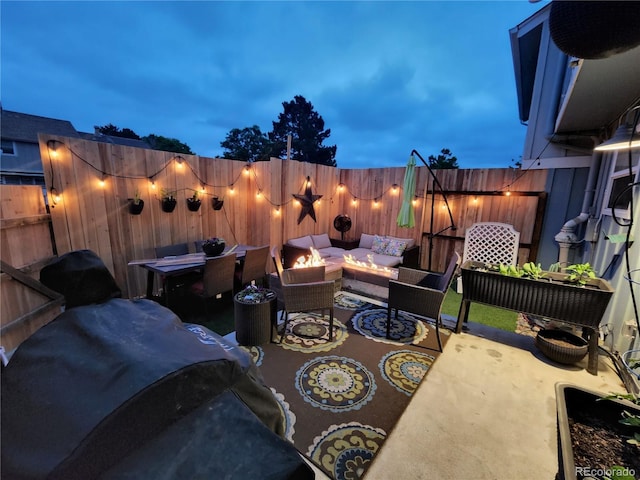 view of patio / terrace with an outdoor living space with a fire pit and a fenced backyard