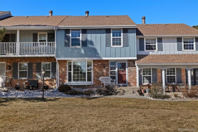 2540 E Geddes Pl, Centennial, CO 80122 - rear view of property featuring board and batten siding, a lawn, brick siding, and roof with shingles
