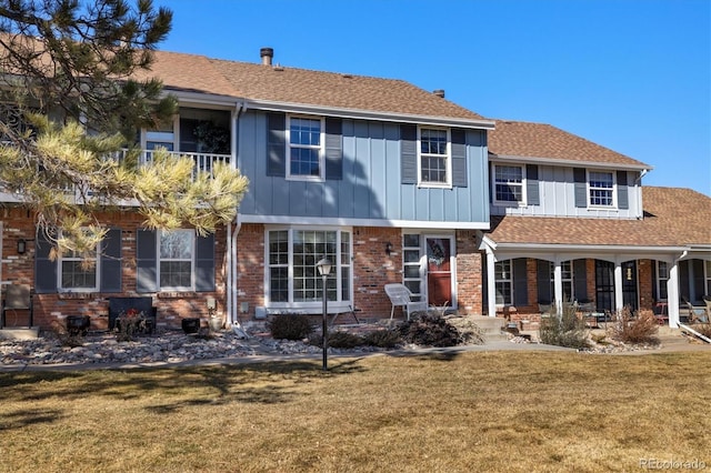 2540 E Geddes Pl, Centennial, CO 80122 - view of front facade featuring a front lawn, board and batten siding, and brick siding