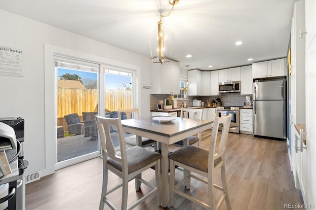 2540 E Geddes Pl, Centennial, CO 80122 - dining space with light wood-type flooring and recessed lighting