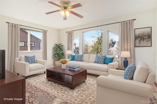 living room featuring a wealth of natural light and ceiling fan