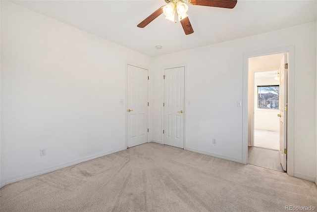 carpeted spare room featuring ceiling fan