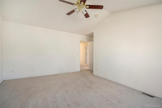 carpeted spare room featuring ceiling fan and lofted ceiling