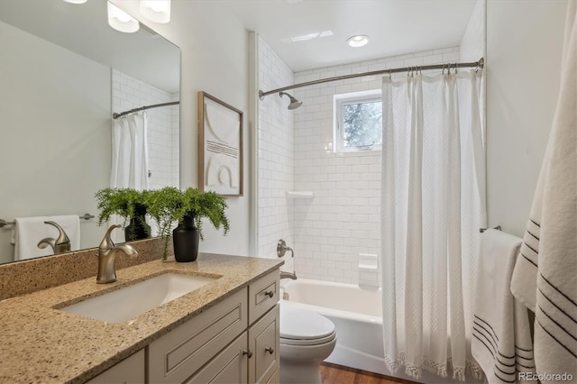 full bath with shower / tub combo, toilet, and vanity