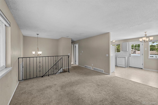 9196 W Maplewood Ave, Littleton, CO 80123 - carpeted spare room with a chandelier and a textured ceiling