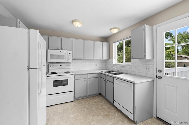 9196 W Maplewood Ave, Littleton, CO 80123 - kitchen with white appliances, gray cabinets, backsplash, and light countertops