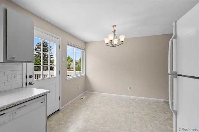 9196 W Maplewood Ave, Littleton, CO 80123 - unfurnished dining area with a chandelier and baseboards