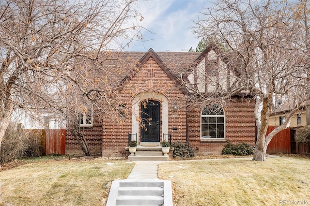 tudor-style house with a front lawn