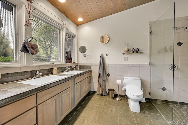 4701 Homestead St, Bow Mar, CO 80123 - bathroom with toilet, a shower stall, tile walls, double vanity, and recessed lighting