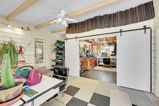 4701 Homestead St, Bow Mar, CO 80123 - office featuring a barn door, tile patterned floors, beamed ceiling, ceiling fan, and wood walls