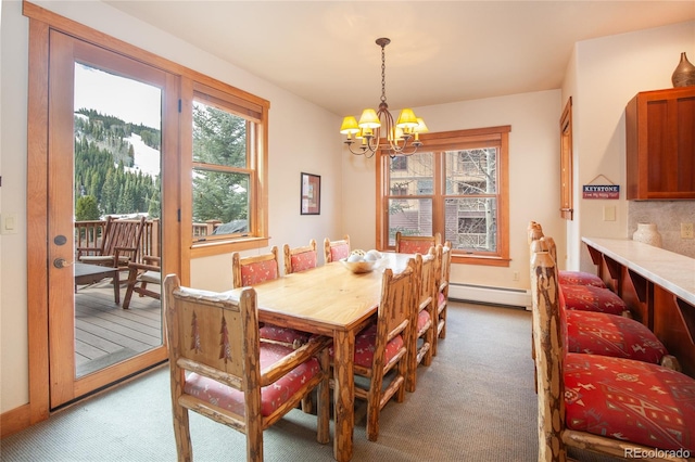 58 Hawk Cir Unit 2342, Dillon, CO 80435 - carpeted dining area with a baseboard radiator and a chandelier