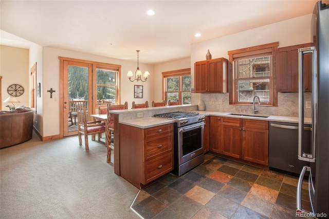 58 Hawk Cir Unit 2342, Dillon, CO 80435 - kitchen featuring hanging light fixtures, a chandelier, kitchen peninsula, appliances with stainless steel finishes, and sink