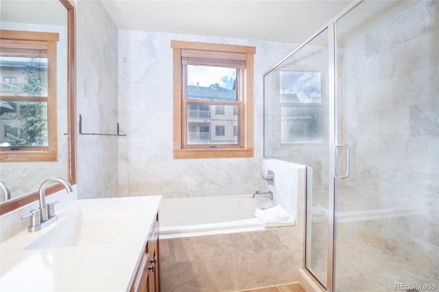 58 Hawk Cir Unit 2342, Dillon, CO 80435 - bathroom featuring tile walls, vanity with extensive cabinet space, and separate shower and tub