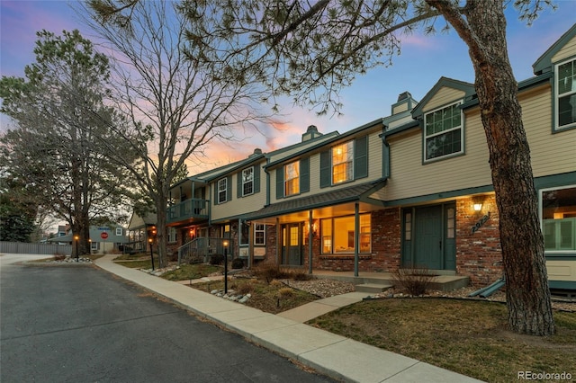 townhome / multi-family property featuring brick siding and a chimney