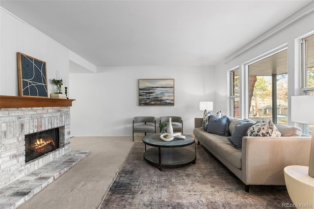 carpeted living area with a fireplace