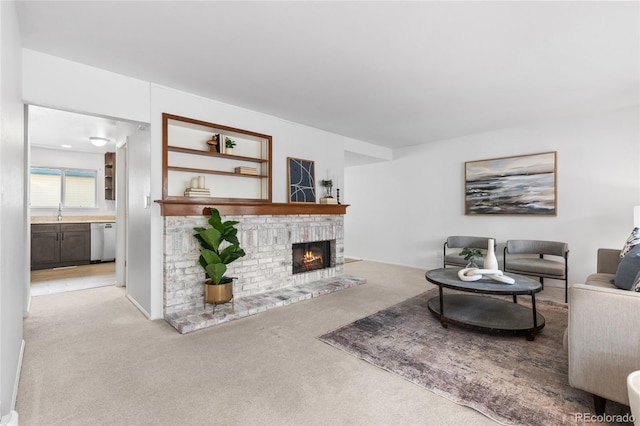 living area featuring light colored carpet and a fireplace