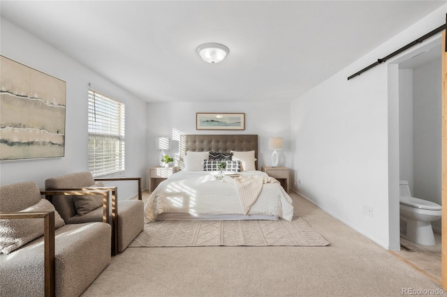 carpeted bedroom featuring a barn door