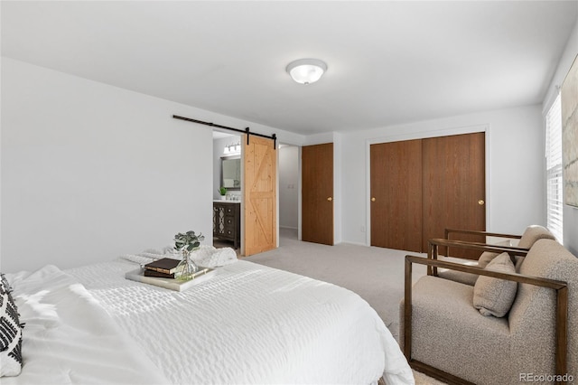 bedroom with a barn door, a closet, and light carpet