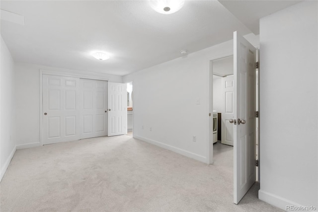 unfurnished bedroom with a closet, baseboards, and carpet