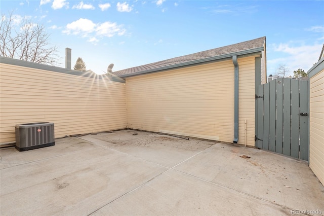 view of patio / terrace with central AC unit and a gate